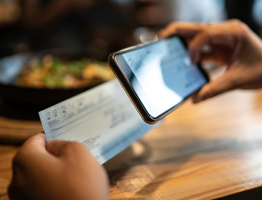 Person scanning a check with their phone.