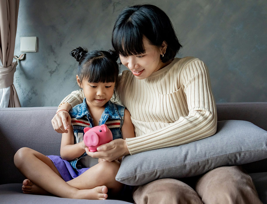 Mother and child with piggy bank.